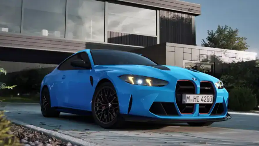 Blauer BMW vor modernem Gebäude bei Tageslicht, Pflanzen im Hintergrund.